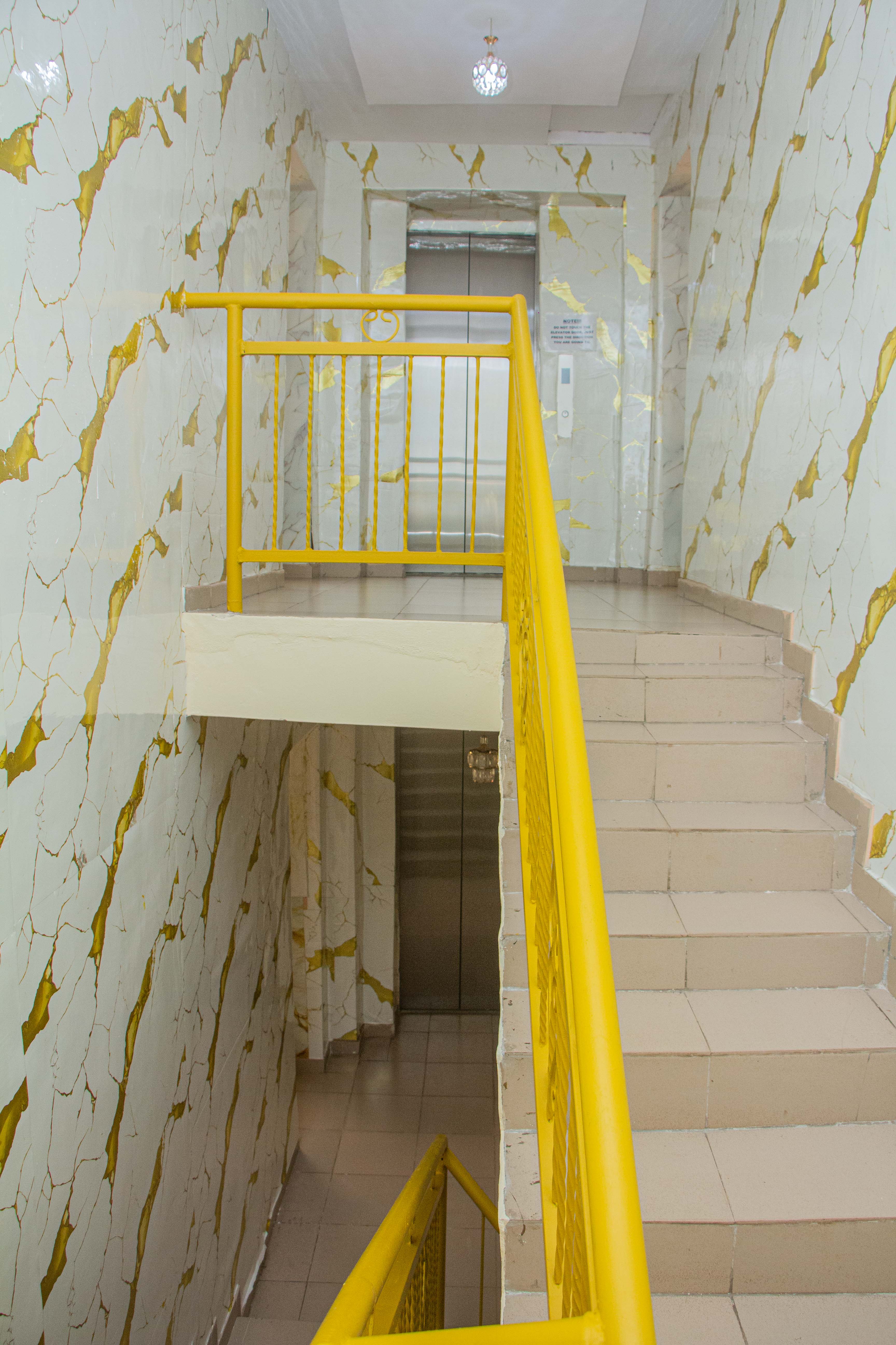 Lobby staircase and lift at L.ade Hotel